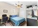 Bedroom featuring a ceiling fan, TV, closet and wooden bed with blue striped comforter at 6948 E Quill St, Mesa, AZ 85207