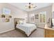 Cozy bedroom with a wooden headboard, white bedding, plantation shutters, and carpet floors at 6948 E Quill St, Mesa, AZ 85207