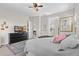 Inviting bedroom featuring a TV, dresser and views to an ensuite bathroom and hallway at 6948 E Quill St, Mesa, AZ 85207