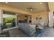 Comfortable covered patio with cozy seating, TV, and an expansive view of the open-concept living area at 6948 E Quill St, Mesa, AZ 85207