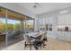 Dining area features a large sliding glass door with access to outdoor dining and landscape views at 6948 E Quill St, Mesa, AZ 85207