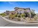 Charming single-Gathering home featuring a stone facade, desert landscaping, and a brick driveway at 6948 E Quill St, Mesa, AZ 85207