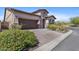 Beautiful single-Gathering home featuring a stone facade, three car garage, and brick driveway at 6948 E Quill St, Mesa, AZ 85207