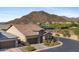 Charming desert home with a tile roof, beautiful stone accents, desert landscaping, and mountain views at 6948 E Quill St, Mesa, AZ 85207