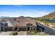 Aerial view of single Gathering home with beautiful mountain views and well manicured desert landscaping at 6948 E Quill St, Mesa, AZ 85207
