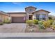 Beautiful desert home with stone accents, desert landscaping, brick driveway, and a two car garage at 6948 E Quill St, Mesa, AZ 85207