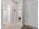 Hallway leading to the front door with views into the bathroom and bedroom at 6948 E Quill St, Mesa, AZ 85207