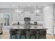 Bright kitchen features an island with seating, modern appliances, and stylish pendant lighting at 6948 E Quill St, Mesa, AZ 85207