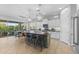Expansive kitchen with a large island, barstool seating, and a view of the outdoor patio at 6948 E Quill St, Mesa, AZ 85207