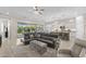 Open living room concept with a large sectional sofa, a view of the kitchen, and sliding glass doors at 6948 E Quill St, Mesa, AZ 85207