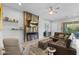 Inviting living room features a cozy fireplace, ceiling fan, and leather sectional sofa at 6948 E Quill St, Mesa, AZ 85207