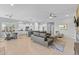 Spacious open-concept living area with a modern kitchen, dining space, and comfortable lounge at 6948 E Quill St, Mesa, AZ 85207