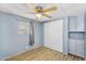 Bedroom with light blue walls, ceiling fan, light-colored wood-look floors, and closet at 747 E Germann Rd # 15, San Tan Valley, AZ 85140