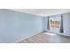 Light-filled bedroom with wood-look flooring and light blue accent wall at 747 E Germann Rd # 15, San Tan Valley, AZ 85140