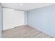 Bedroom featuring wood-look flooring, light blue accent wall, and closet with sliding doors at 747 E Germann Rd # 15, San Tan Valley, AZ 85140