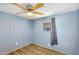 Light blue bedroom featuring ceiling fan, wood-look floors, window, and wall-mounted outlets at 747 E Germann Rd # 15, San Tan Valley, AZ 85140