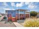 Cozy single-story home with a covered porch, well-maintained landscaping, and a charming outdoor seating area at 747 E Germann Rd # 15, San Tan Valley, AZ 85140