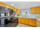 Bright kitchen features light wood cabinets, a black appliance package, and light backsplash at 747 E Germann Rd # 15, San Tan Valley, AZ 85140