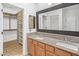 Bathroom features a double sink vanity with granite counters and a walk-in closet at 7601 E Roosevelt St # 1012, Scottsdale, AZ 85257