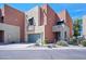 Modern two-story townhome featuring a two-car garage, landscaped front yard, and a stucco exterior finish at 7601 E Roosevelt St # 1012, Scottsdale, AZ 85257