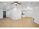Open concept living space with wood-look floors, ceiling fan, and easy access to the kitchen at 7601 E Roosevelt St # 1012, Scottsdale, AZ 85257