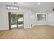 Open living area with sliding doors, wood-look floors, recessed lighting, and lots of natural light at 7601 E Roosevelt St # 1012, Scottsdale, AZ 85257