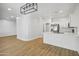 Spacious living room featuring wood-look flooring, modern lighting, and seamlessly connected to the kitchen at 7601 E Roosevelt St # 1012, Scottsdale, AZ 85257