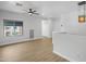 Upstairs loft featuring wood-look floors, a ceiling fan, and ample natural light from the windows at 7601 E Roosevelt St # 1012, Scottsdale, AZ 85257