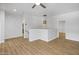 Open loft area with wood-look flooring, neutral walls, and a view of the stairs at 7601 E Roosevelt St # 1012, Scottsdale, AZ 85257