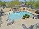 A beautiful pool area featuring lounge chairs, lush landscaping, and a relaxing pergola with table and chairs at 7601 E Roosevelt St # 1012, Scottsdale, AZ 85257
