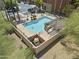 An amazing pool area featuring a pergola, landscaping, ample seating, and an adjacent utility enclosure at 7601 E Roosevelt St # 1012, Scottsdale, AZ 85257
