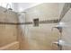 Close up of custom shower with tiled walls and a built-in shelf at 7601 E Roosevelt St # 1012, Scottsdale, AZ 85257