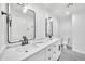 Modern bathroom with dual sinks, marble countertop, and sleek black fixtures at 8436 N 13Th N Pl, Phoenix, AZ 85020