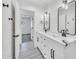 Bathroom with a double vanity, white cabinets, and a black faucet at 8436 N 13Th N Pl, Phoenix, AZ 85020