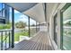 Covered deck, featuring wood flooring, black railings, and view of the yard and fence at 8436 N 13Th N Pl, Phoenix, AZ 85020