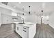 Bright kitchen features an island with a marble countertop, stainless steel appliances, and modern pendant lighting at 8436 N 13Th N Pl, Phoenix, AZ 85020