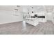 Elegant kitchen featuring white cabinets, a central island, and luxury appliances in an open layout at 8436 N 13Th N Pl, Phoenix, AZ 85020