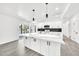 Bright kitchen with a large island, marble countertops, modern cabinets, and stainless steel appliances and hardware at 8436 N 13Th N Pl, Phoenix, AZ 85020
