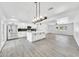 Modern kitchen with white cabinets, stainless steel appliances, an island, and an open view to the living area at 8436 N 13Th N Pl, Phoenix, AZ 85020