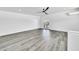 Bright living room with gray wood floors, white walls and a ceiling fan at 8436 N 13Th N Pl, Phoenix, AZ 85020