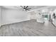 Bright, open living area with luxury wood-look tile floors and a contemporary ceiling fan at 8436 N 13Th N Pl, Phoenix, AZ 85020