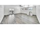 Open living room with gray wood-look flooring, modern lighting, and a balcony at 8436 N 13Th N Pl, Phoenix, AZ 85020