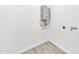 Utility room with a modern tankless water heater and tile floor at 8436 N 13Th N Pl, Phoenix, AZ 85020