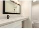 Modern bathroom features a white vanity with an undermount sink, and stylish lighting fixture at 8928 E Crescent Ave, Mesa, AZ 85208