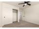 Bedroom with carpet, ceiling fan, and closet provides comfortable living and ample storage space at 8928 E Crescent Ave, Mesa, AZ 85208
