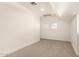 Neutral carpeted bedroom featuring two small windows with natural light at 8928 E Crescent Ave, Mesa, AZ 85208