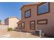 Two-story house backyard view with neutral toned stucco and brown trim at 8928 E Crescent Ave, Mesa, AZ 85208