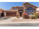 Charming two-story home featuring a well-manicured front yard, a two car garage and a classic tiled roof at 8928 E Crescent Ave, Mesa, AZ 85208