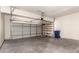 Spacious two-car garage with large door and overhead lighting at 8928 E Crescent Ave, Mesa, AZ 85208