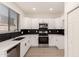 Modern kitchen with stainless steel appliances, sleek countertops, and stylish backsplash at 8928 E Crescent Ave, Mesa, AZ 85208